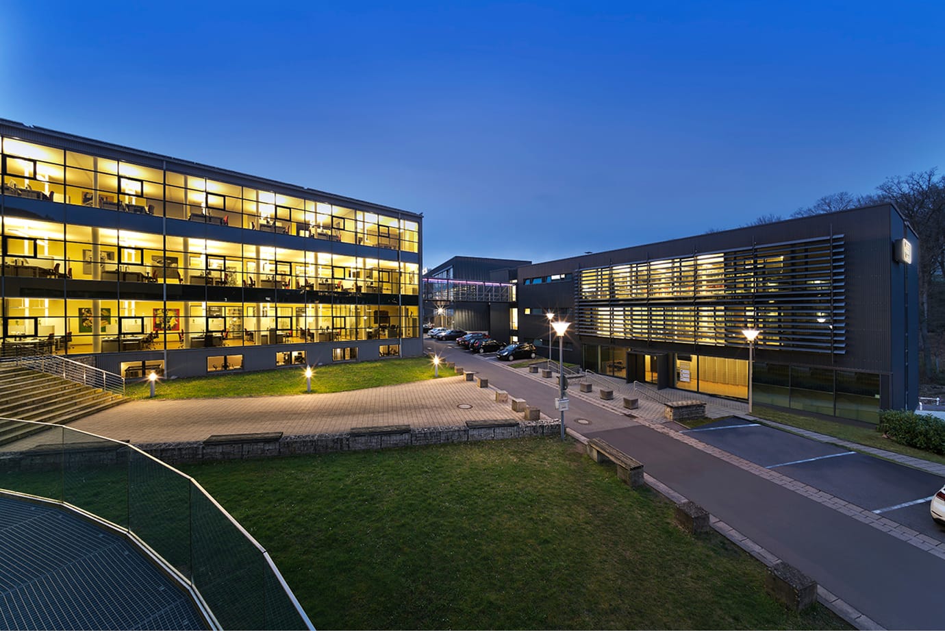 DHfPG University building at night with illuminated windows